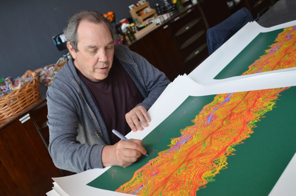 John Hermann signing Soundwaves art prints benefiting Tunes for Tots